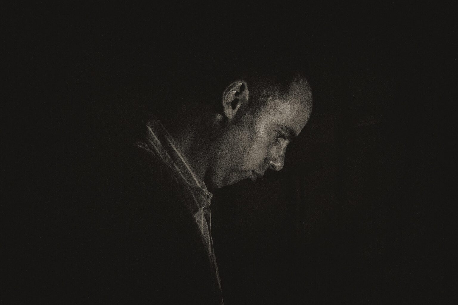 This image captures a lonely man in a moment of silence.